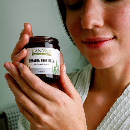 Breathe Free Balm being held in hand