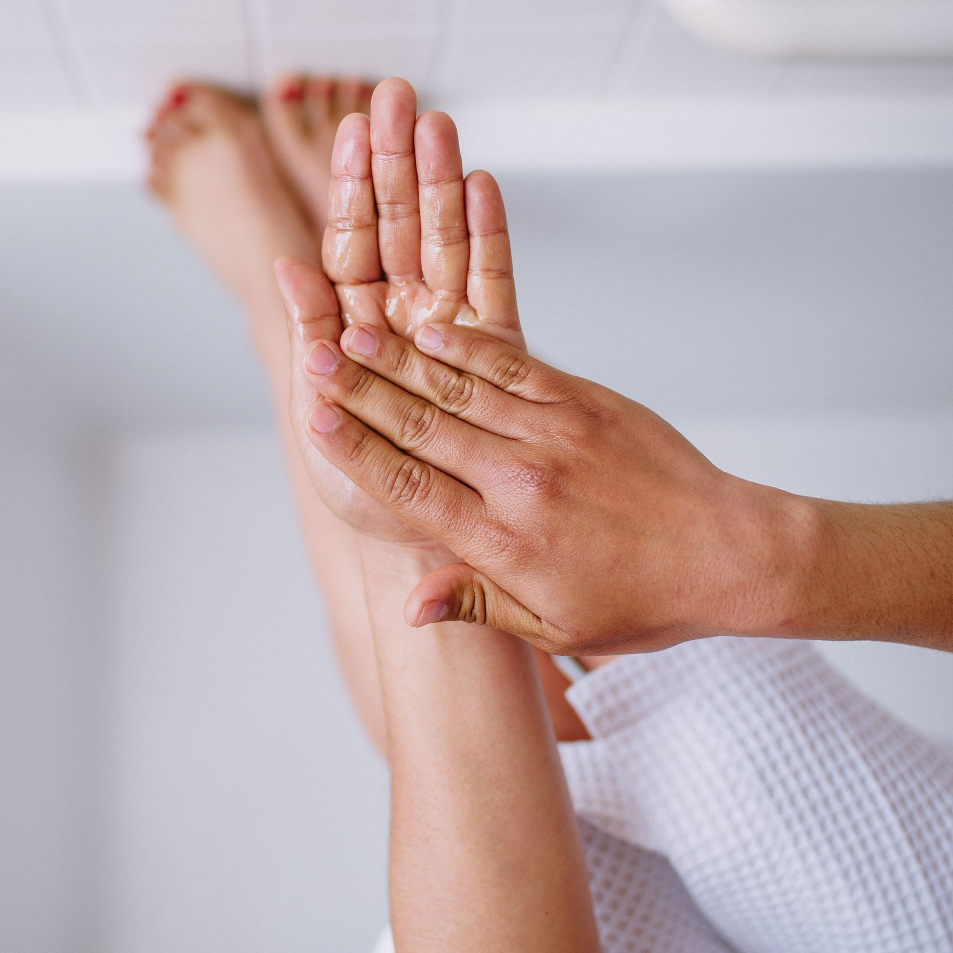 Woman oiling hands and arms